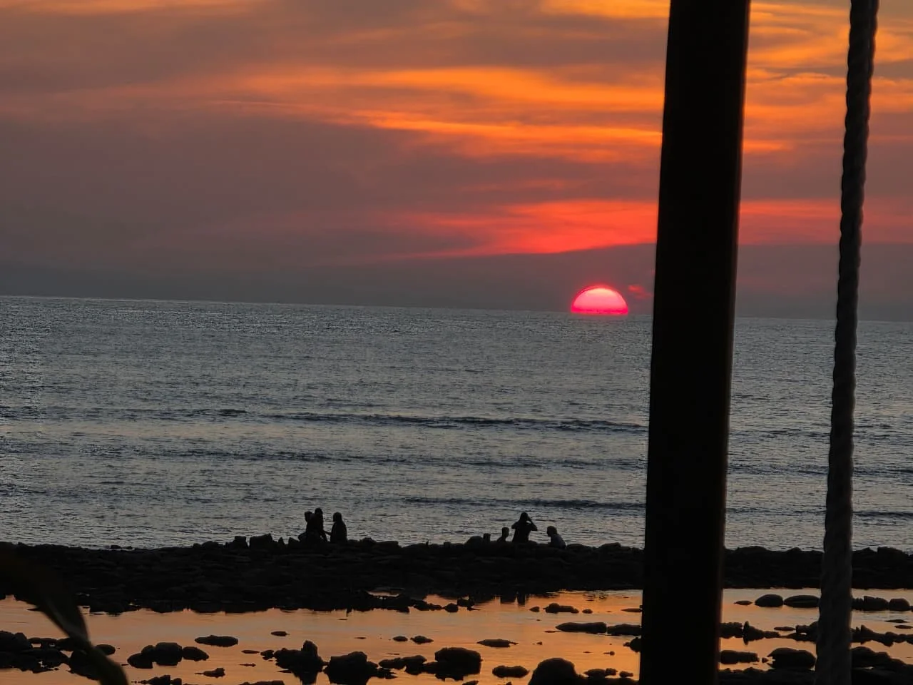The red sun setting over the sea