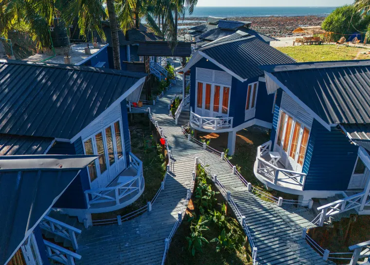 Paths and villas woven through the palms
